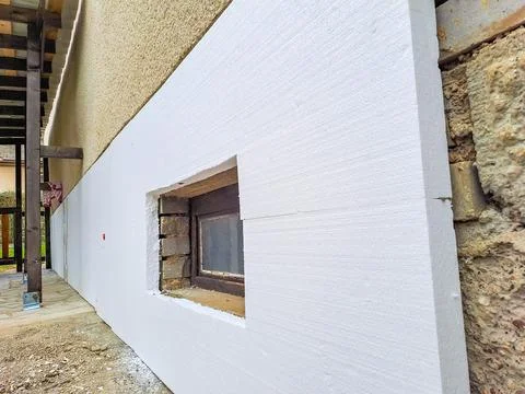 Installing rigid styrofoam insulation board for energy saving of the house wall Stock Photos