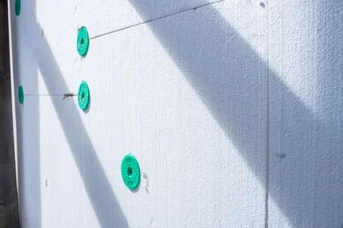 Installing rigid styrofoam insulation board for energy saving of the house wall Stock Photos
