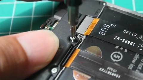 Installing screws on a mobile phone Stock Footage 293324883