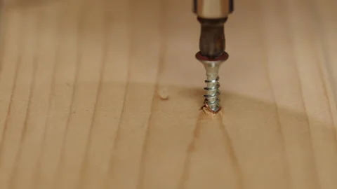 Installing a screws in the wooden board Stock Footage 146012947