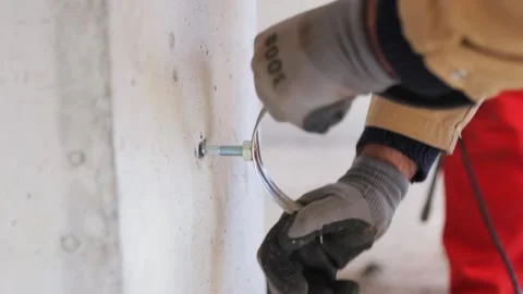 Installing Sewer Pipe Holder: Wall Construction Close-up Stock Footage 271582952