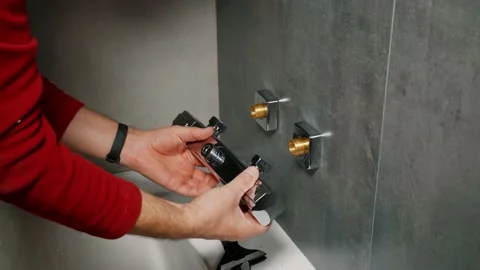 Installing a shower faucet in the bathroom. Stock Footage 133884864
