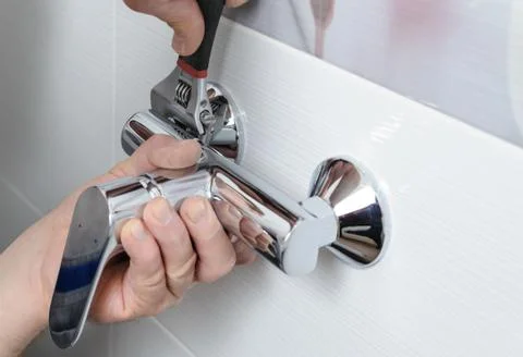 Installing a shower faucet. Stock Photos