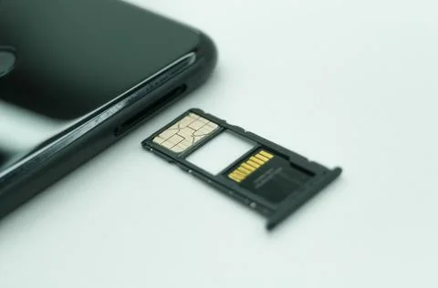 Installing a SIM card in a mobile phone. Open tray for SIM cards and micro Stock Photos