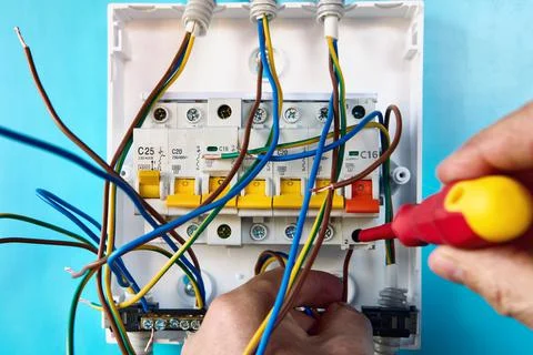 Installing of single phase consumer unit for household electrical network. Stock Photos