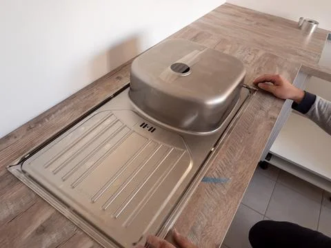 Installing the sink in the kitchen, preparing to cut a hole in the worktop fo Stock Photos