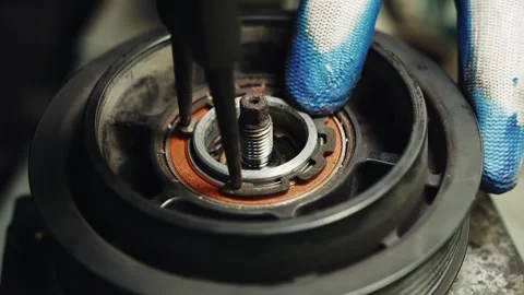 Installing a snap ring or retainer ring a fastener that holds a bearing in an Stock Footage 285641749