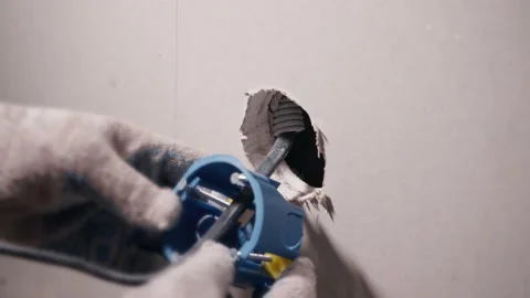 Installing a socket or switch in the wall Stock Footage 200131984