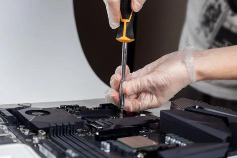 Installing the solid state hard drive on the computer motherboard Stock Photos