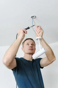 Installing a spotlight in the room. Stock Photos