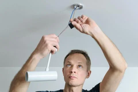 Installing a spotlight in the room. Stock Photos