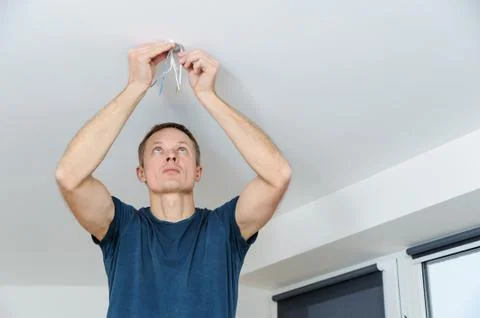 Installing a spotlight in the room. Stock Photos