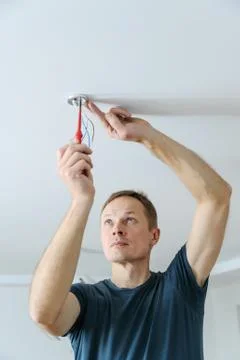 Installing a spotlight in the room. Stock Photos