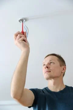 Installing a spotlight in the room. Stock Photos