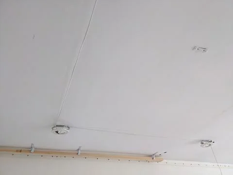 Installing a stretch ceiling on a laser level. Stock Photos