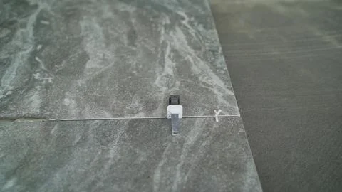 Installing tile fasteners on the floor. Fasteners for ceramic tiles. Close-up Stock Photos