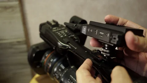 Installing the transmitter on the video camera. Stock Footage 130144417