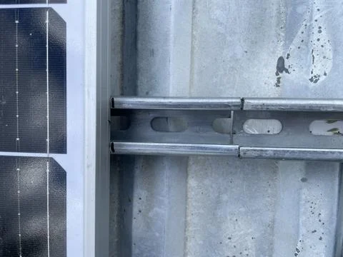 Installing two solar panels on roof Stock Photos