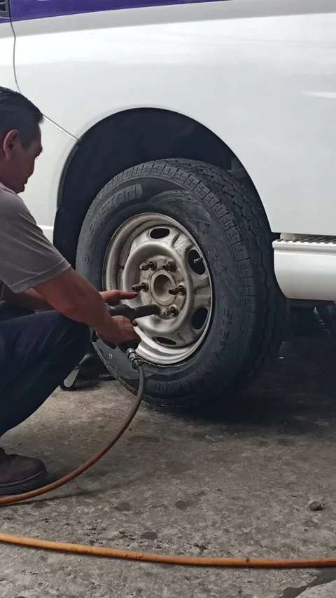 Installing tyre nut using air gun Stock Footage 278437861