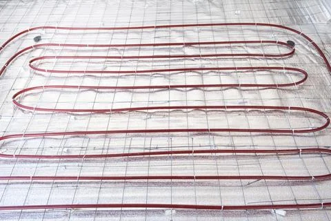 Installing underfloor heating system, laying heating pipes on insulation, f.. Stock Photos