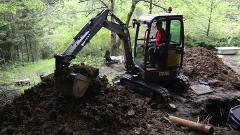 Installing underground plastic tank. Construction site of small water well Stock Footage 251644455