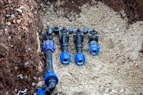 Installing underground sprinkler system 2 Stock Photos