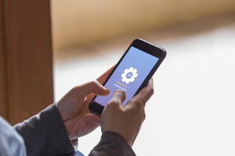 Installing update concept on phone screen. Hands holding phone doing installing  Foto stock
