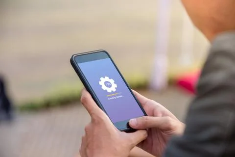 Installing update concept on phone screen. Man holding phone doing installing up Stock Photos