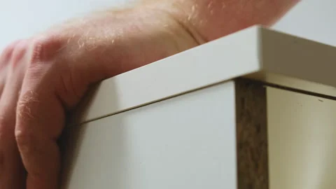 Installing upper board of shelf with dowel pins in apartment Stock Footage 304401013