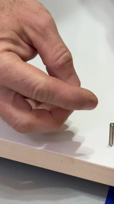 Installing upper board of shelf with wooden dowel pins in apartment closeup. Man Vídeos de archivo 323512377