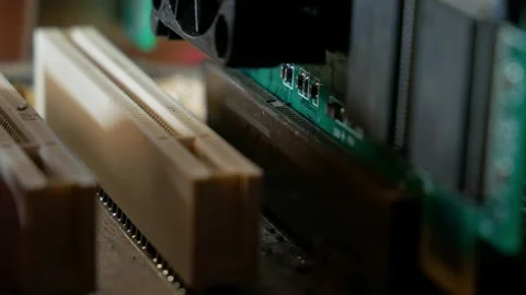 Installing a video adapter into a computer motherboard slot close-up Stock Footage 284479597