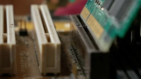 Installing a video adapter into a computer motherboard slot close-up Stock Footage 284479602