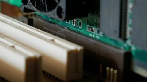 Installing a video adapter into a computer motherboard slot close-up Stock Footage 284479619