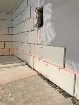 Installing Wall Tiles Using a Laser Level Stock Photos