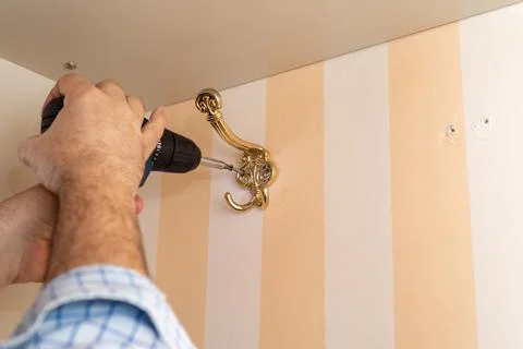 Installing a wardrobe hook Stock Photos
