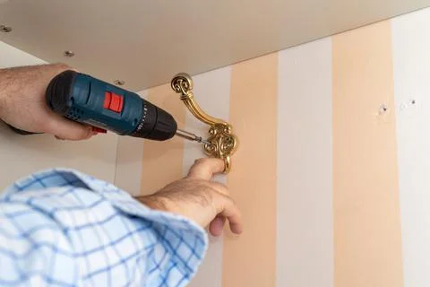 Installing a wardrobe hook Stock Photos