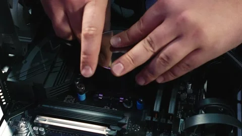 Installing water block onto the CPU during water cooling system assembly Stock Footage 328986515