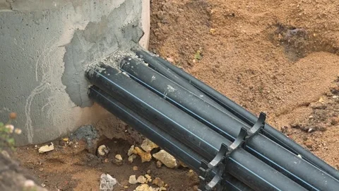 Installing a water drainage system using pipes and a concrete base. The project 動画素材 344675734