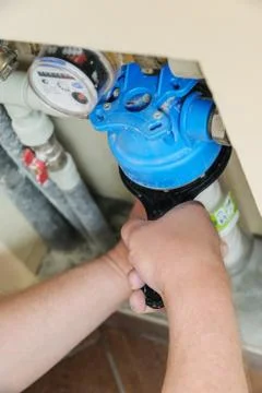 Installing a water filter in a plumbing. Stock Photos