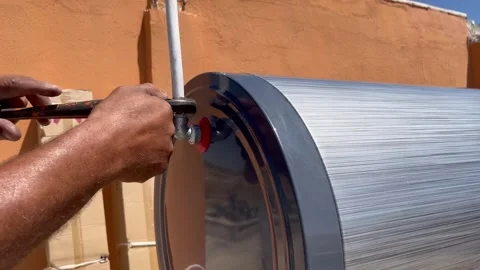 Installing a Water Heater Fitting with a Wrench Stock Footage 345209872