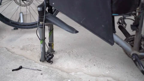 Installing the wheel on the bike frame Stock Footage 129515978