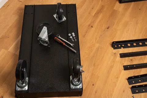 Installing wheels on rolling tool chest base Stock Photos