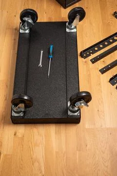 Installing wheels on rolling tool chest base Stock Photos