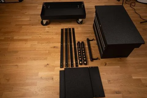 Installing wheels on rolling tool chest base Stock Photos