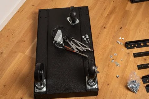Installing wheels on rolling tool chest base Stock Photos
