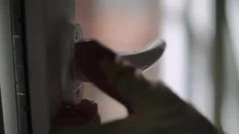 Installing a Window Handle on a Plastic Window Stock Footage 324839757
