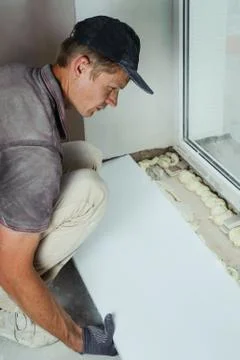 Installing window sill Stock Photos