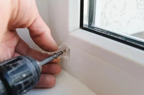 Installing wooden blinds. Stock Photos