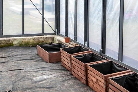 Installing Wooden Planter Boxes With Liner Inside Greenhouse Growing Area Stock Photos