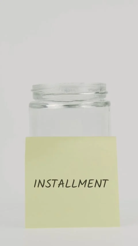 Installment text or word on yellow sticky note attached to glass jar Vídeo Stock 311745239